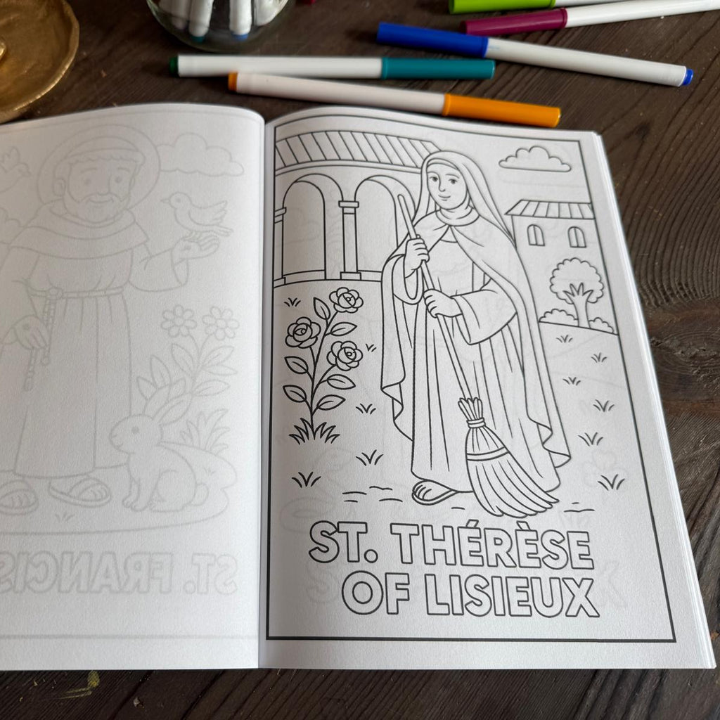 Open coloring book with illustrations on a wooden surface, surrounded by markers.