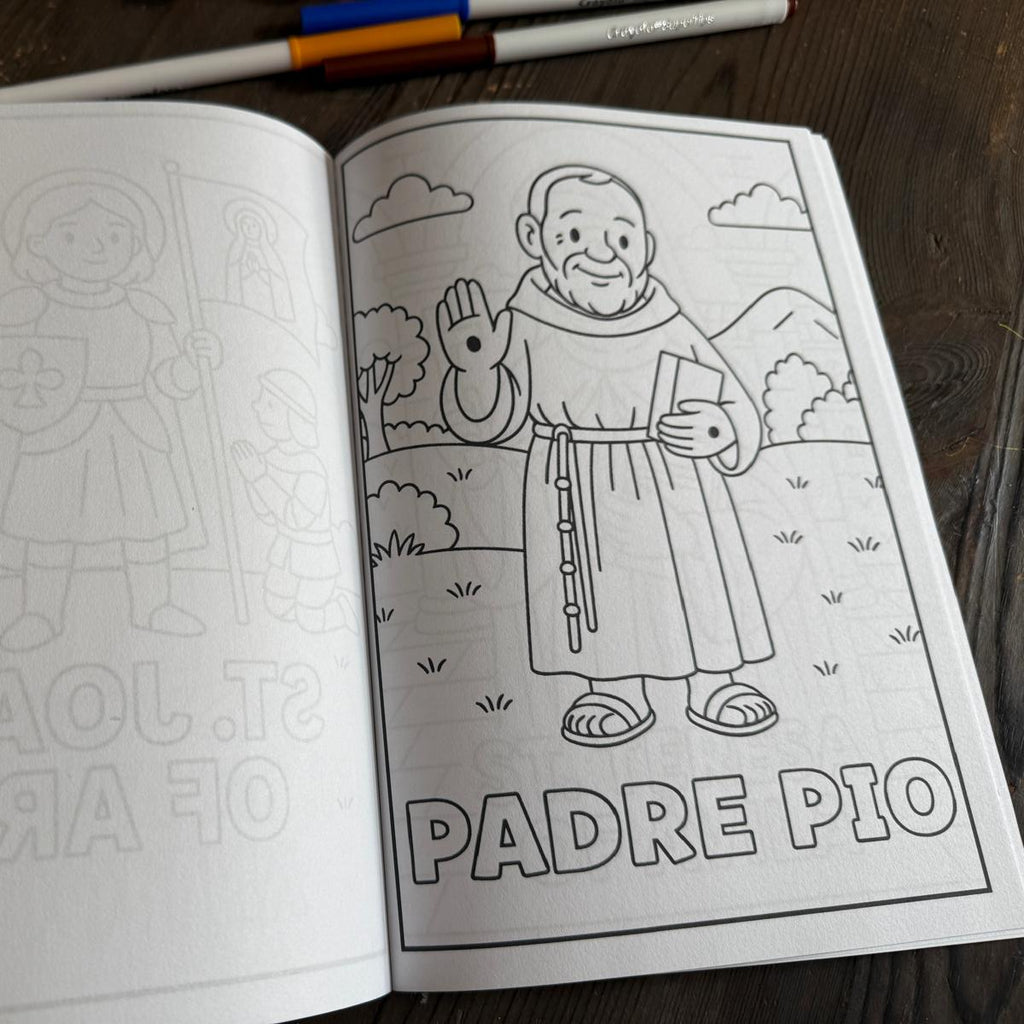 Coloring book open to a page with illustrations and text, on a wooden surface.